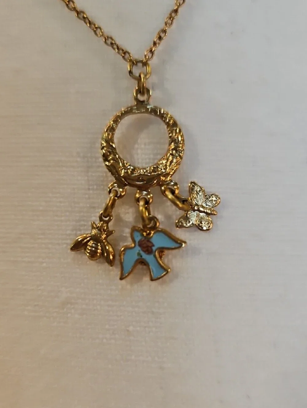 1928 Gold-Tone Circle Necklace with Blue Enamel Bird Bee Butterfly Charms